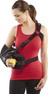 woman wearing the DonJoy UltraSling IV Shoulder Support Sling, experiencing the comfort and support provided by the soft padded adjustable straps and contoured cushion design