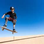 young man with skateboard and full ankle equipment