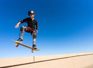 young man with skateboard and full ankle equipment