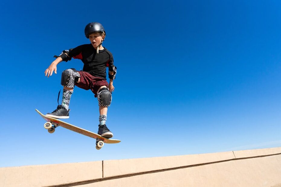 young man with skateboard and full ankle equipment