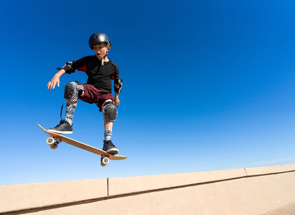 young man with skateboard and full ankle equipment