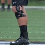 Football player confidently tackles with a sturdy knee brace for added support